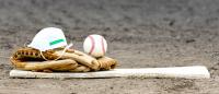 Baseball, glove, and medical mask on pitcher's mound.